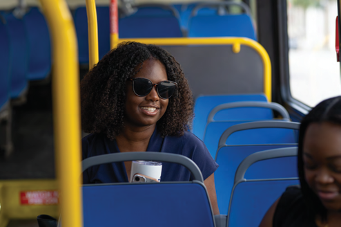 A rider smiling while sitting on a CARTA bus